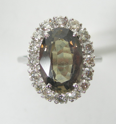 A green sapphire and diamond cluster ring,