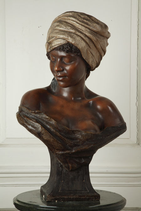 A late 19th/early 20th century Austrian painted terracotta bust of a Nubian girl by Goldscheider