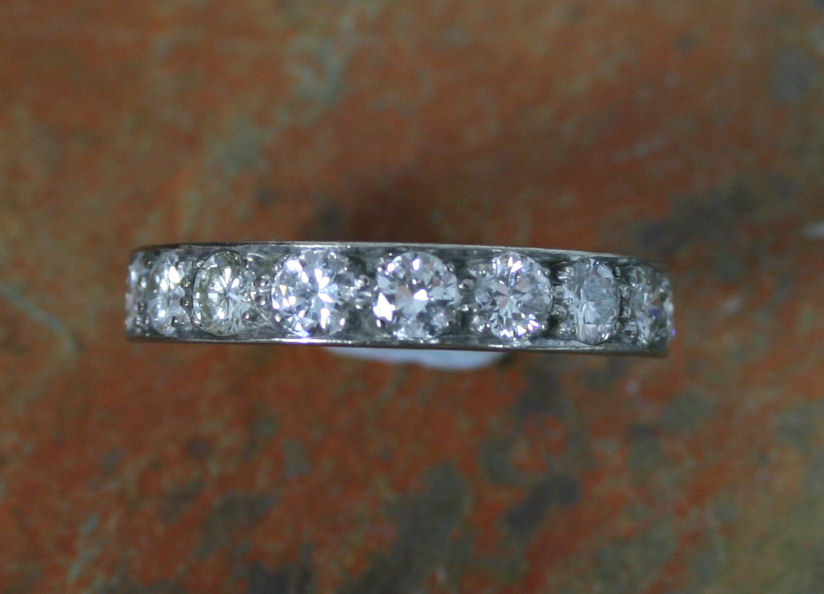 An 18ct white gold mounted diamond half-eternity ring,