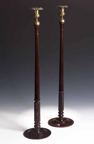 A pair of tall George III mahogany table candlesticks