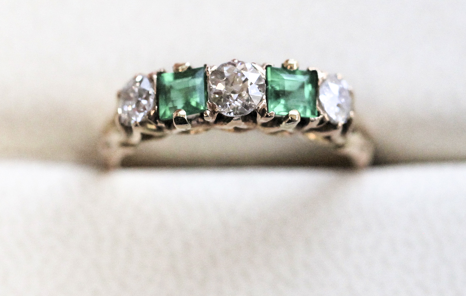 An emerald and diamond ring