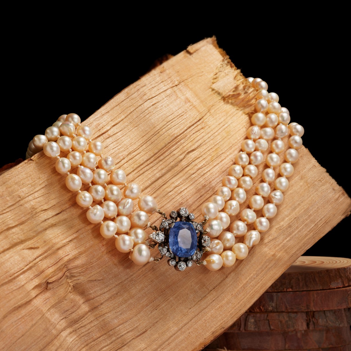 A multi-strand cultured pearl necklace with a late 19th century sapphire and diamond clasp