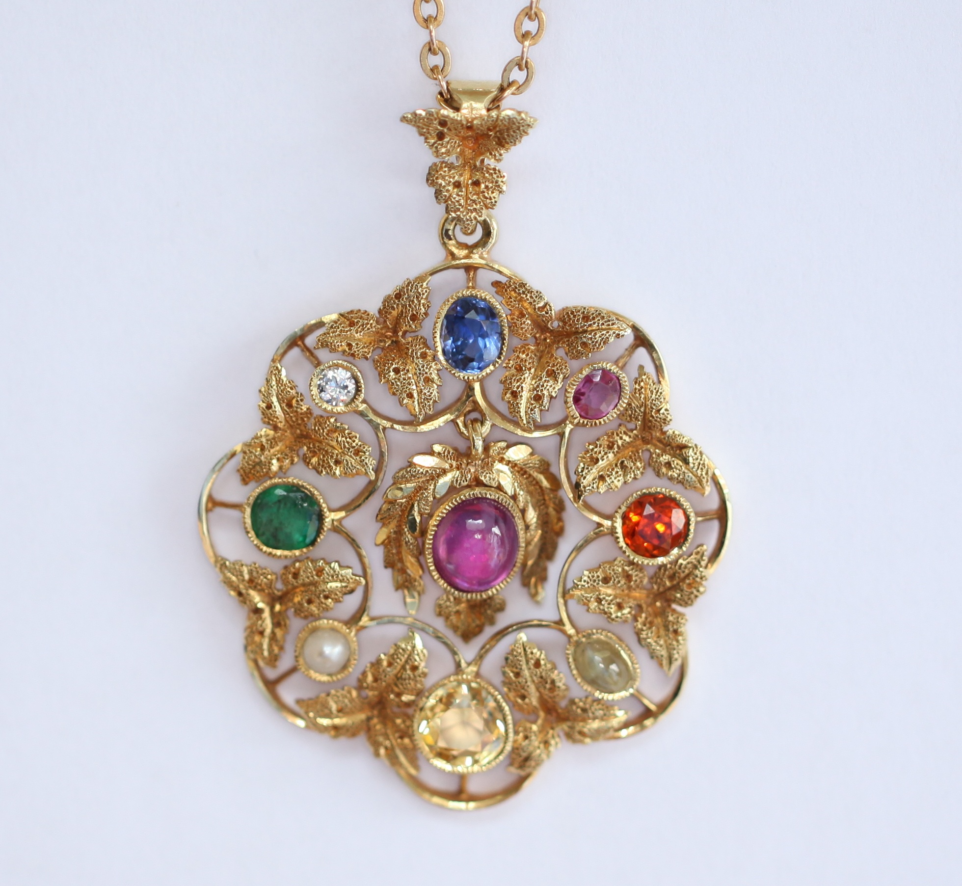 OF ASTROLOGICAL INTEREST - a multi-gem set pendant with chain