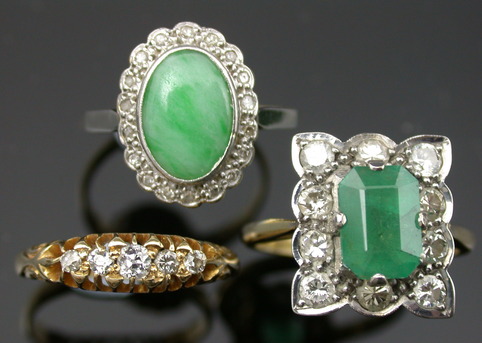 An 18ct gold mounted emerald and diamond ring,