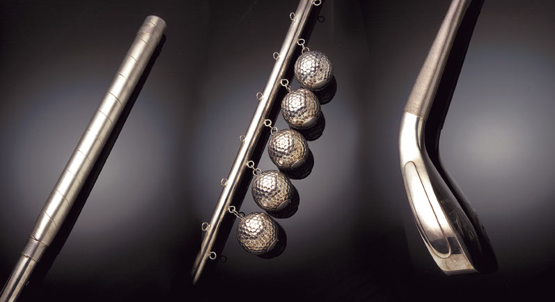 A silver golf club, formed as a replica of a McEwan, Edinburgh, long nose play club,