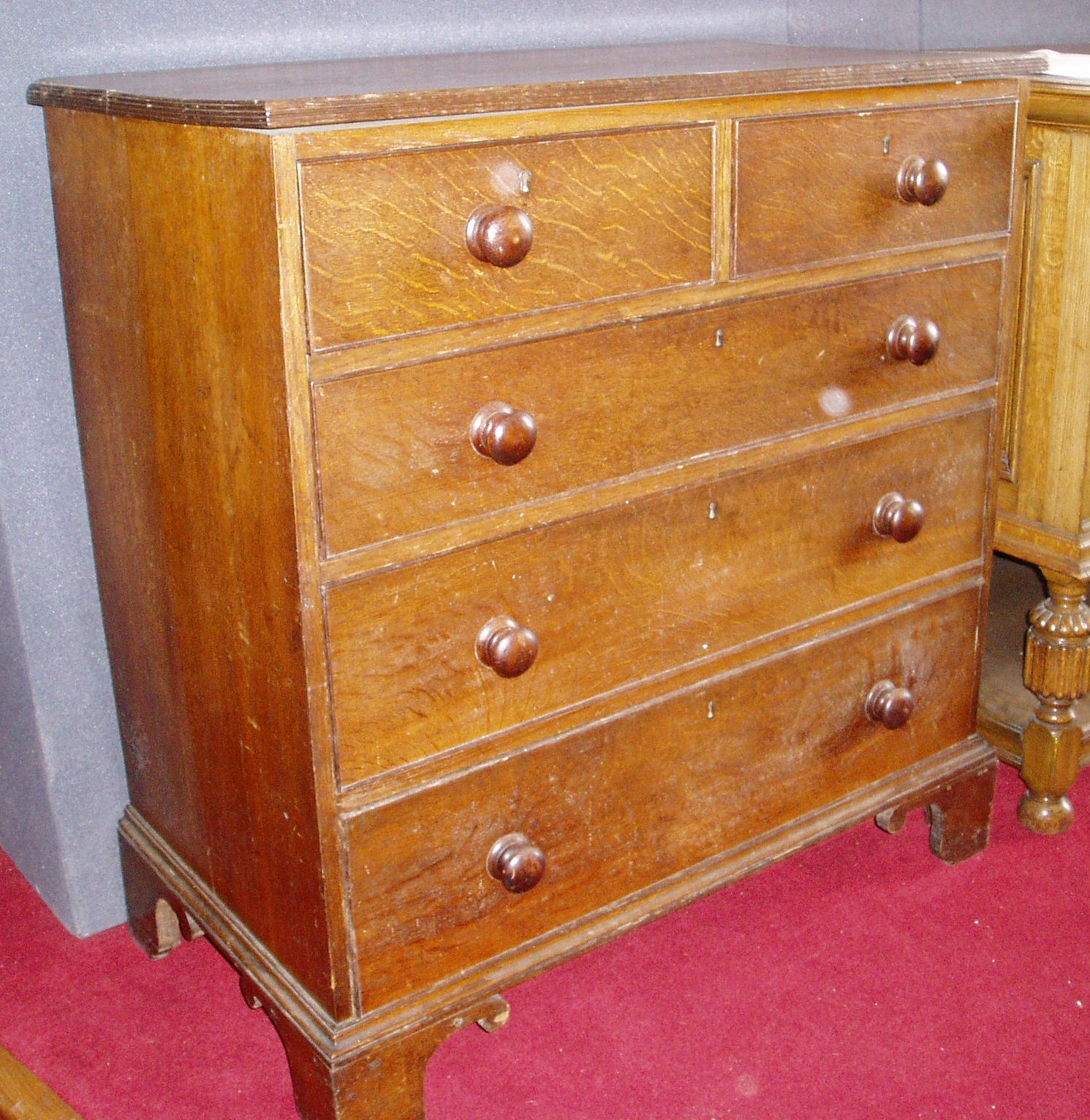 An oak chest of two short over three graduated long drawers,