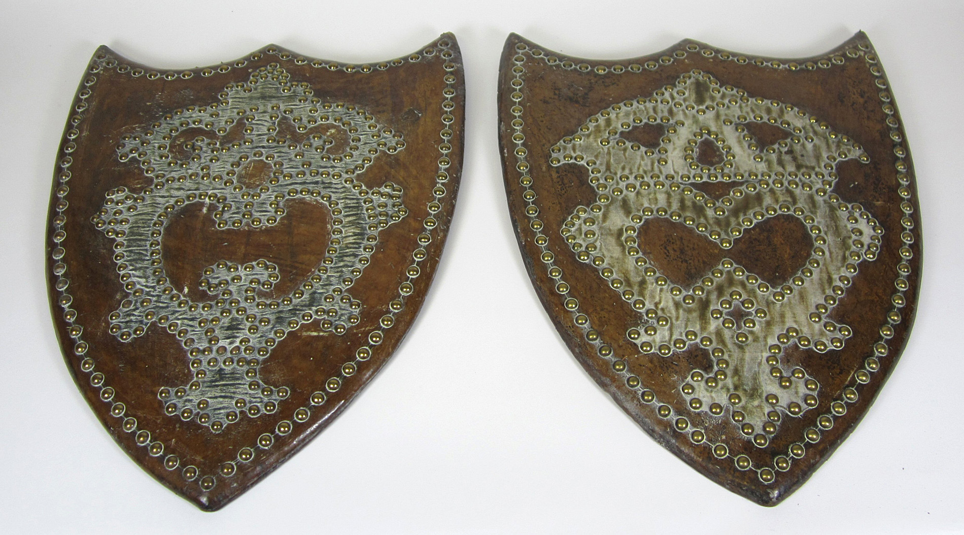 TWO BRASS STUDDED LEATHER DISPLAY SHIELDS