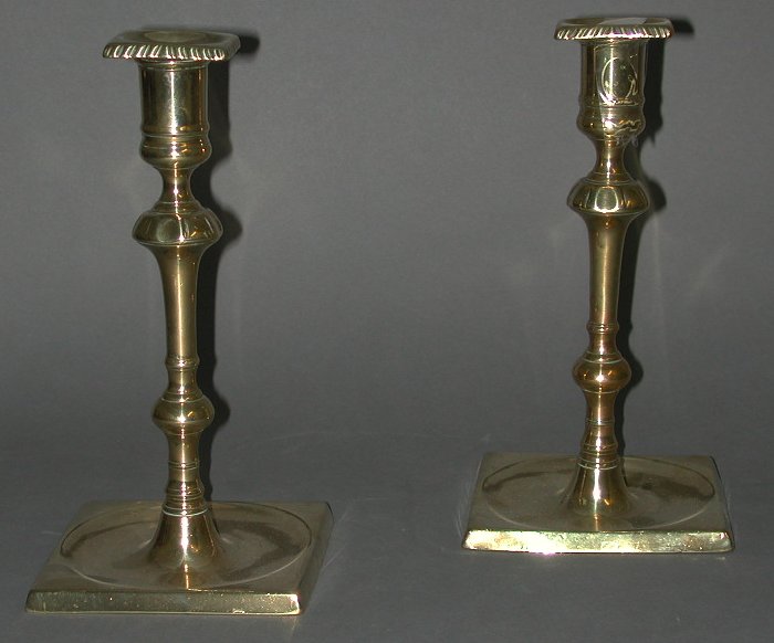 A pair of early 18th century cast brass candlesticks