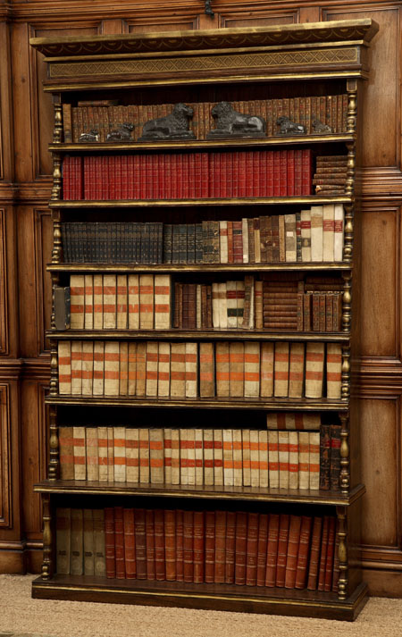 A faux rosewood and gilt waterfall bookcase