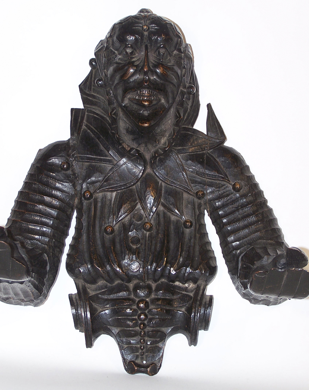 A 19th century carved oak wall mounted figure of a jester