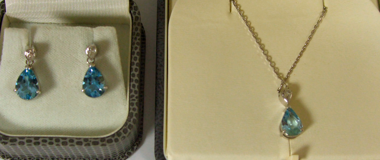 Eric N Smith; an 18ct white gold diamond and aquamarine suite comprising