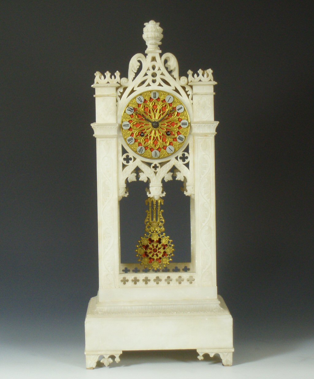 A Victorian gothic revival alabaster clock