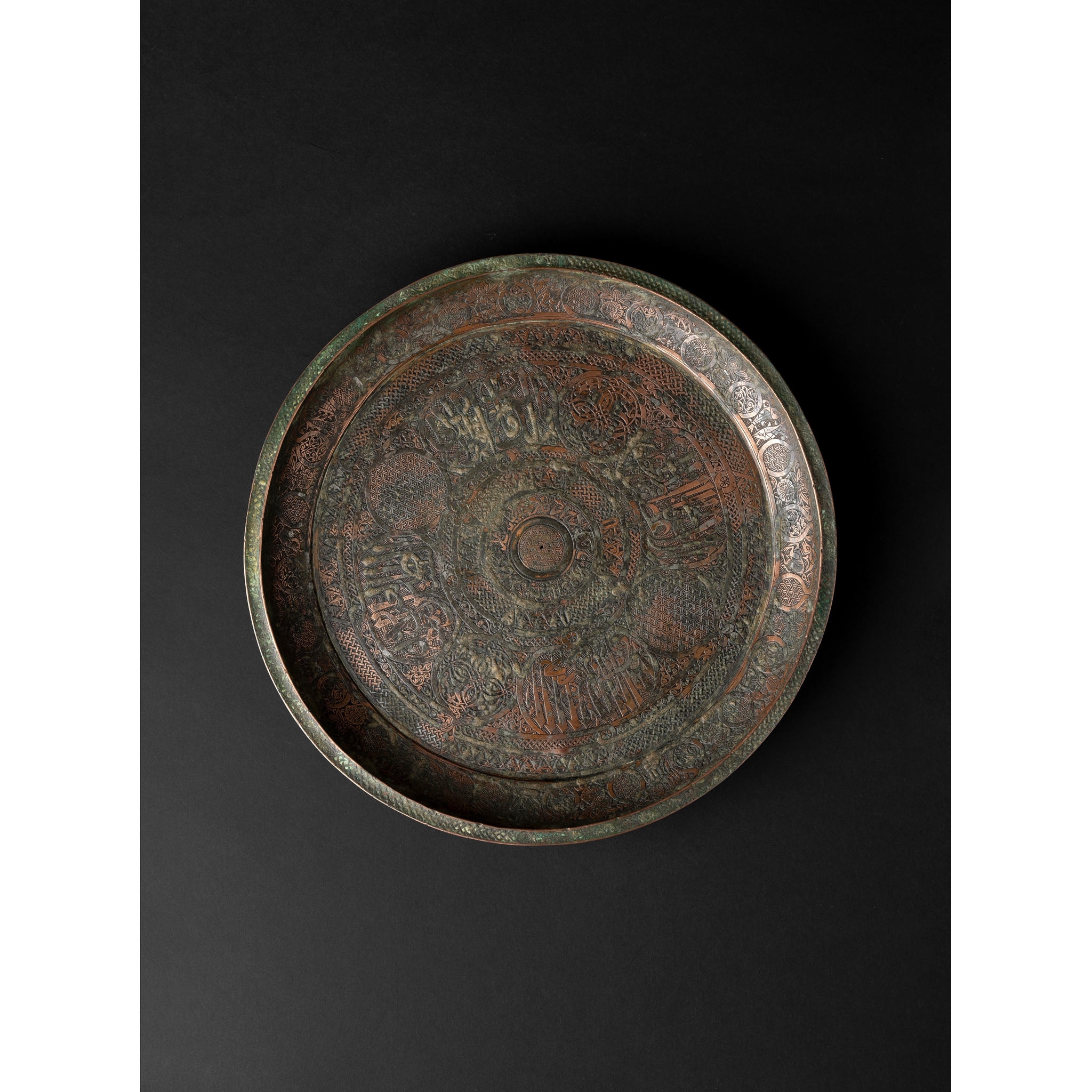 A RARE TIMURID TINNED-COPPER DISH WITH THE TWELVE SIGNS OF THE ZODIAC