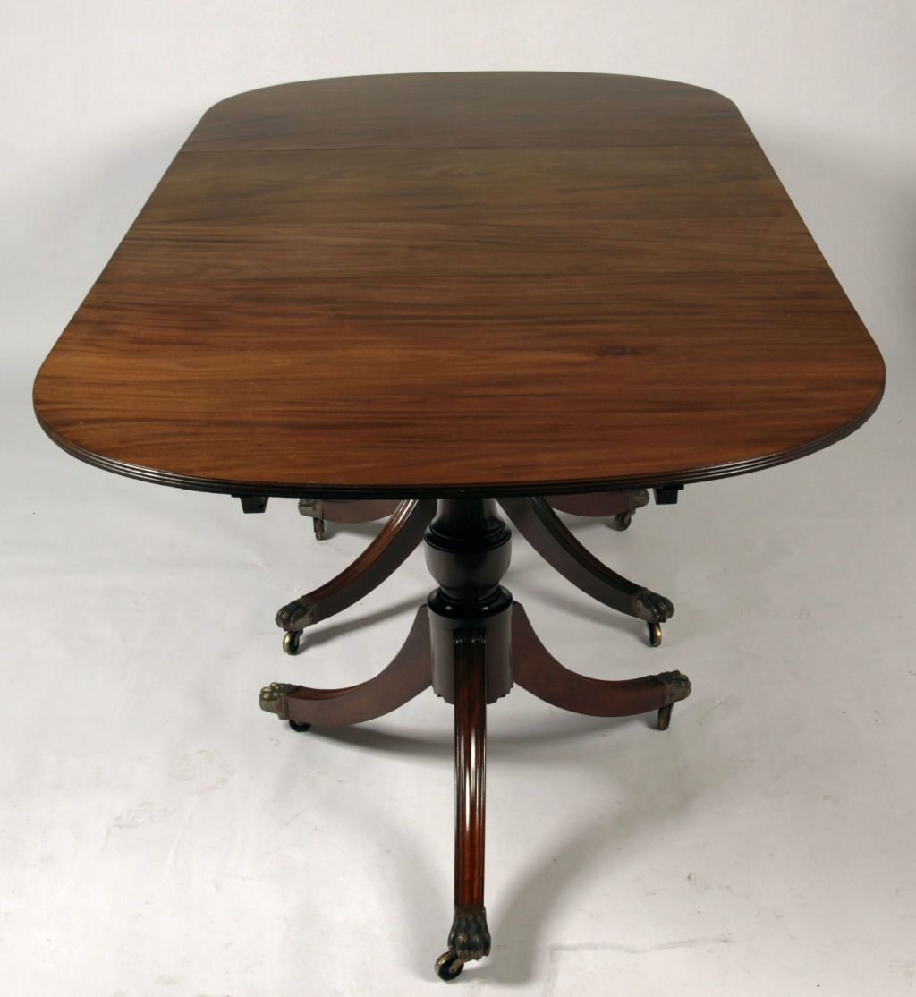 A Regency style mahogany triple pedestal dining table