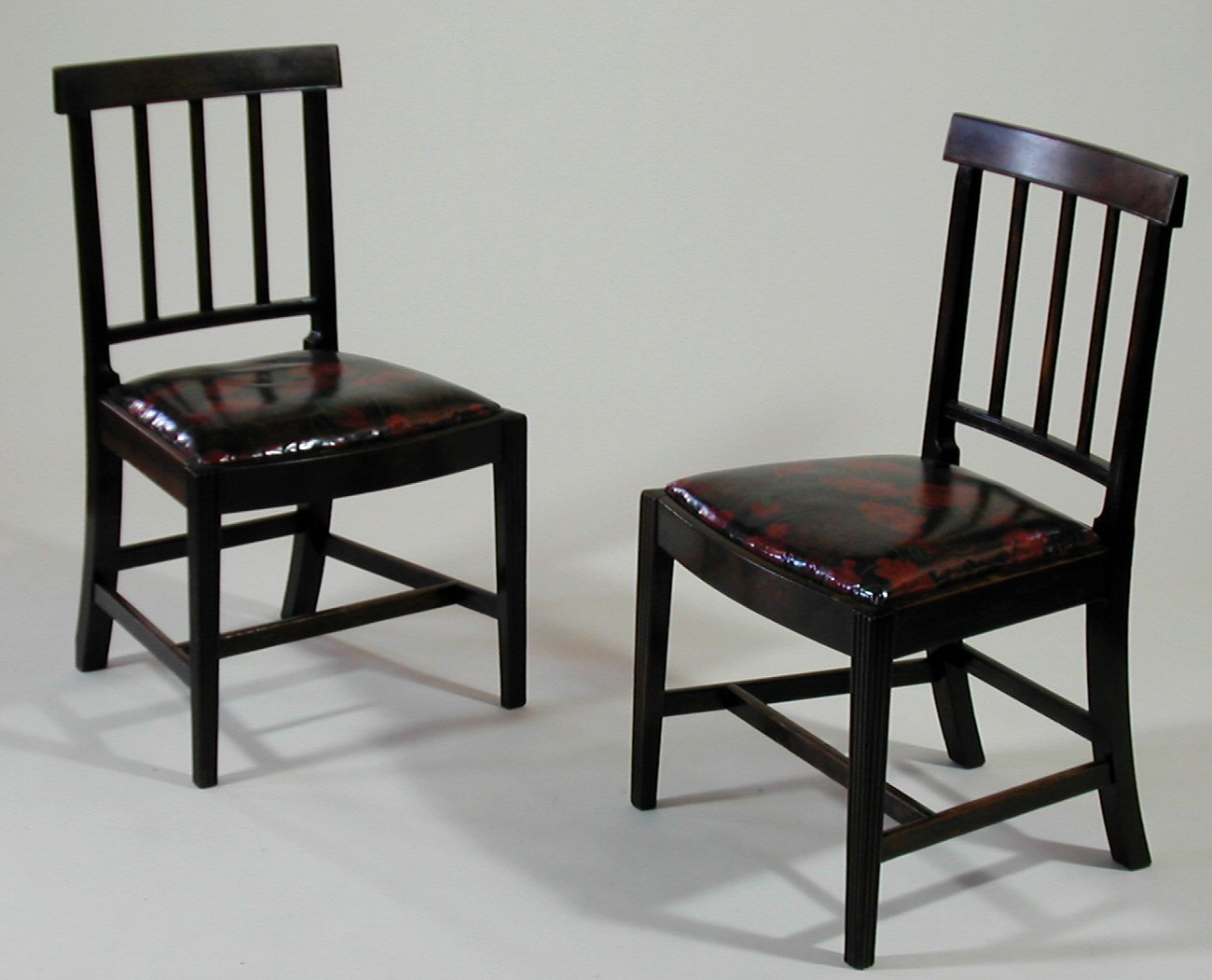 A set of four George III mahogany brander back chairs,