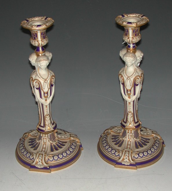A pair of Mintons part glazed Parian Ware caryatid candlesticks