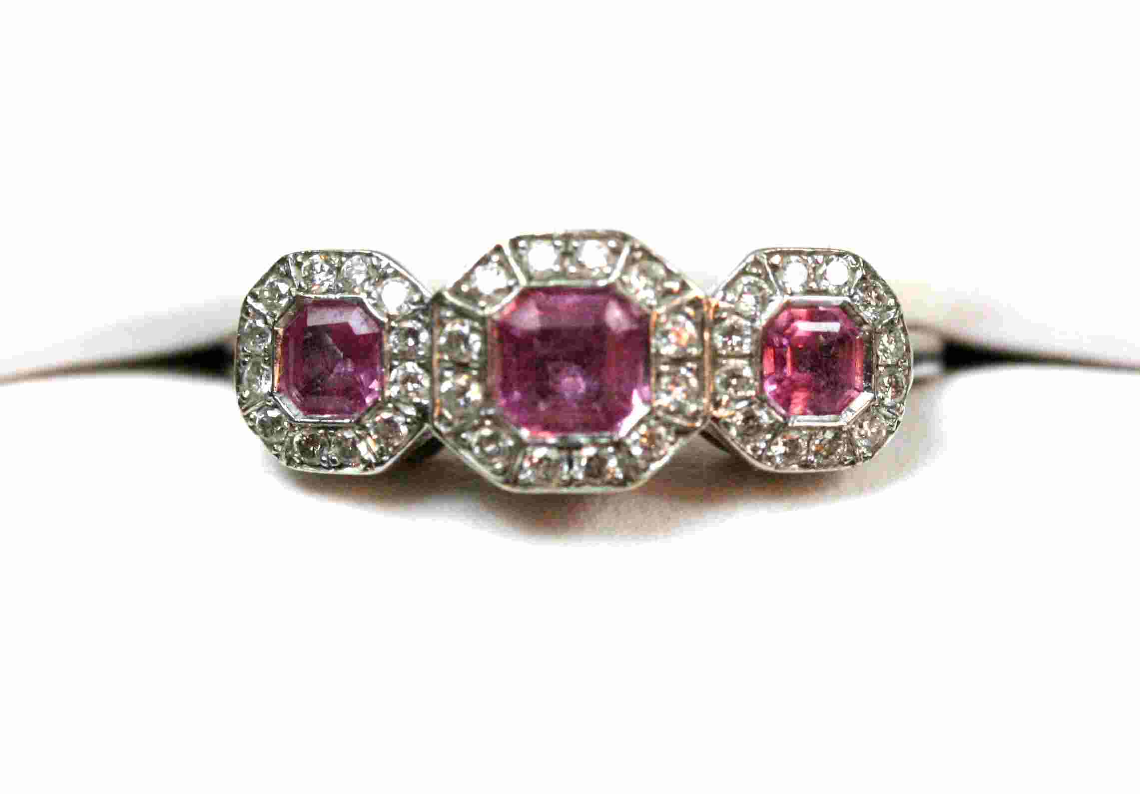 A pink sapphire and diamond set ring