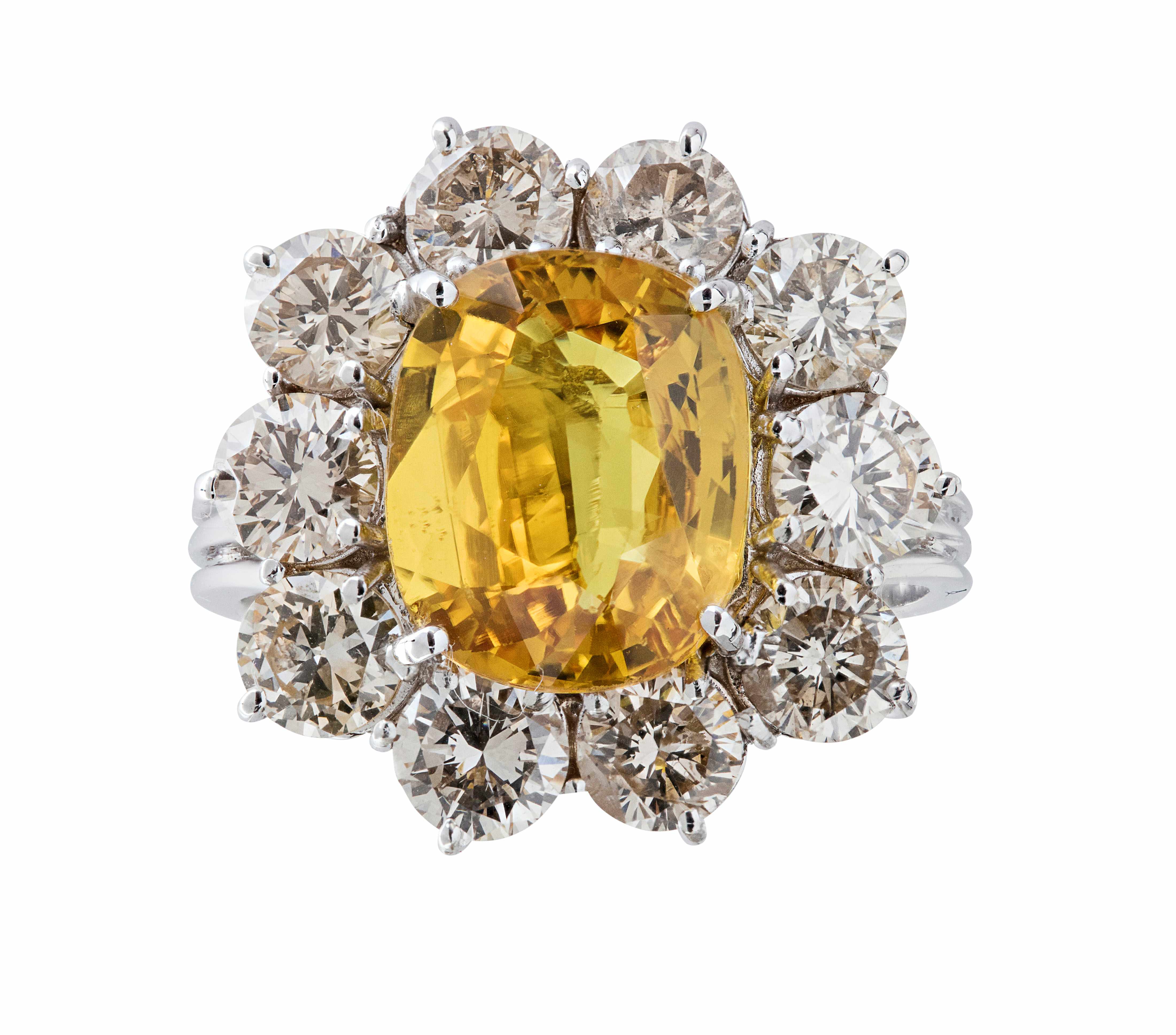 A yellow sapphire and diamond cluster ring