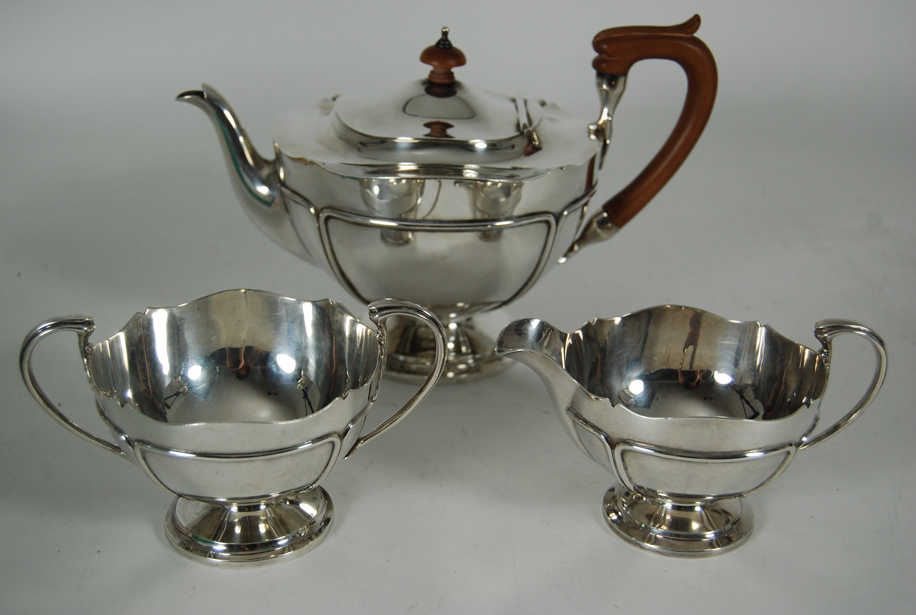 A modern three piece silver tea set