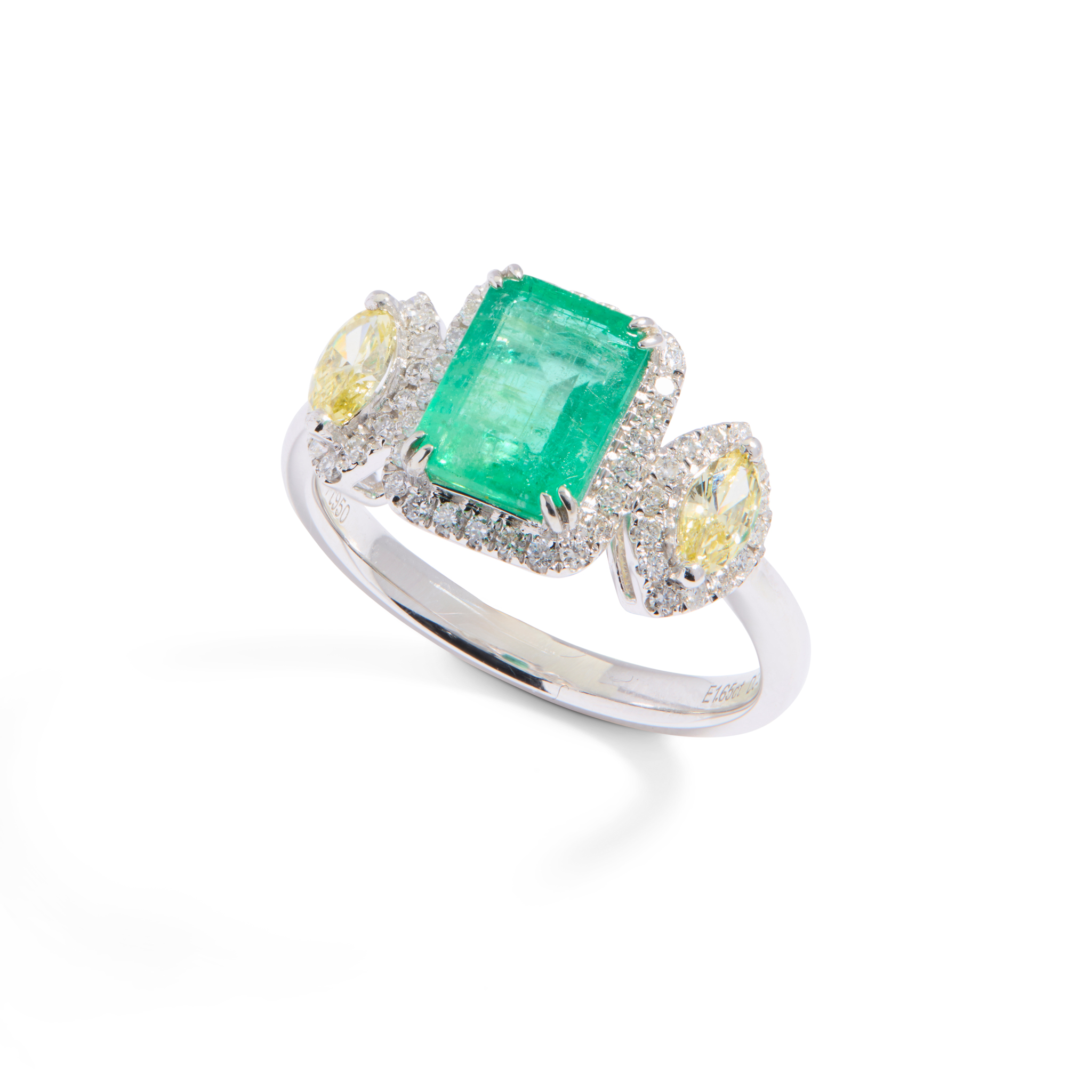 A platinum emerald, yellow and white diamond ring