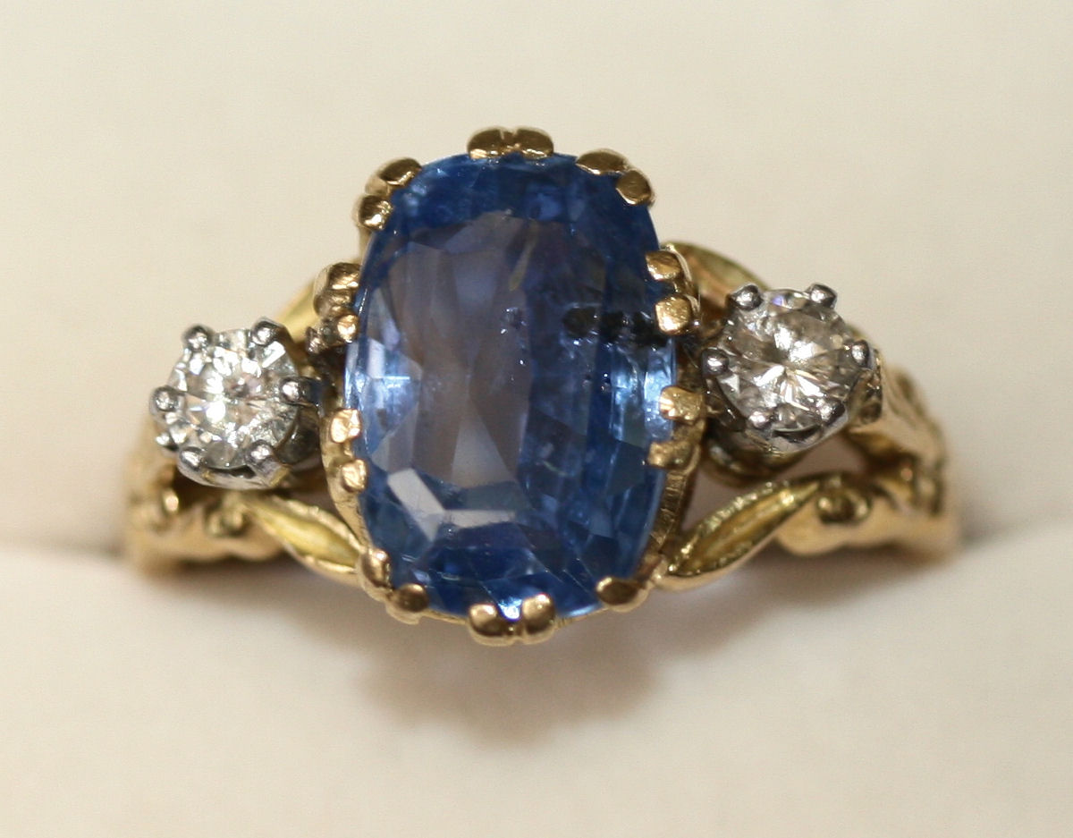 A sapphire and diamond three-stone ring