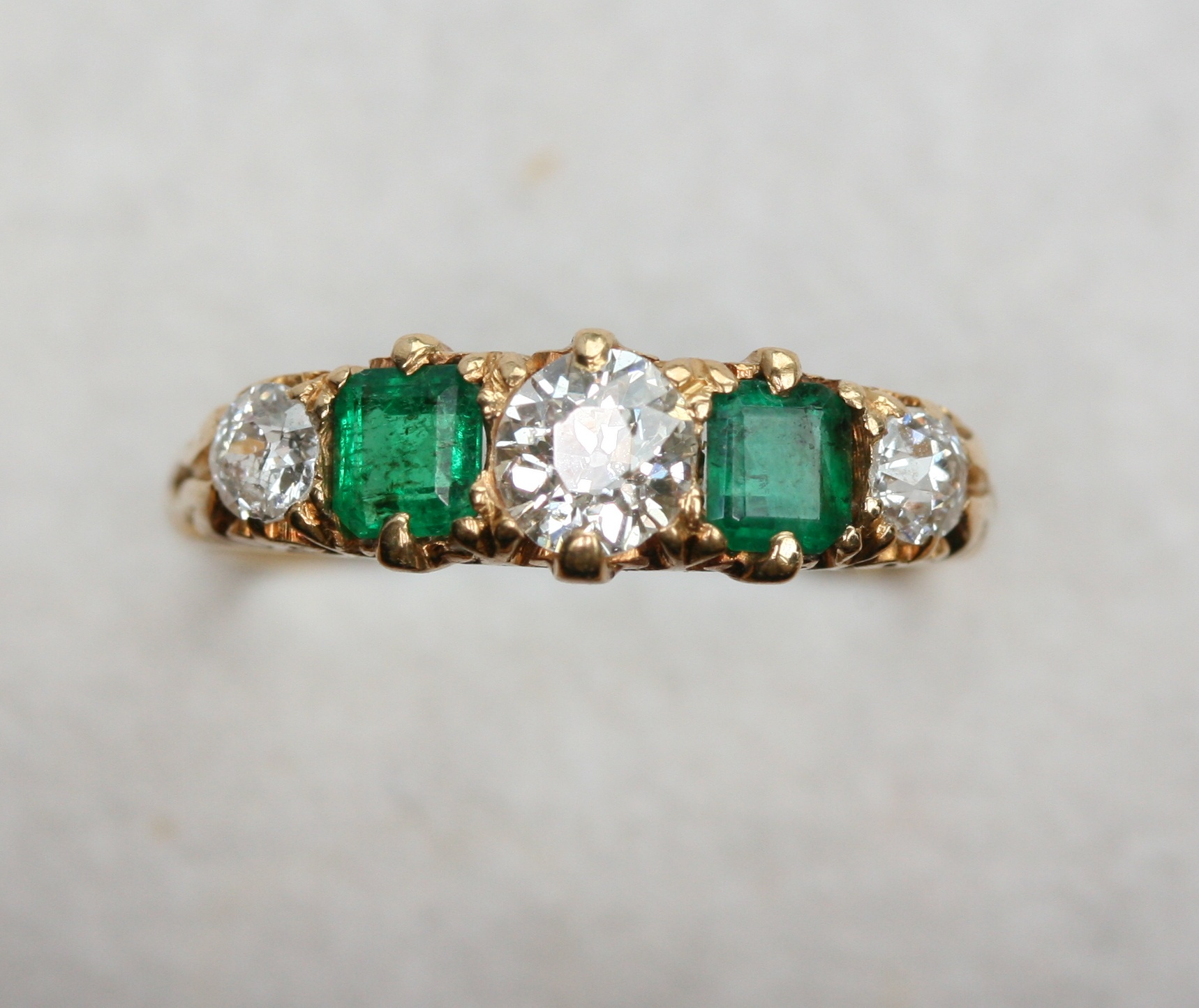 An early 20th century emerald and diamond five stone ring