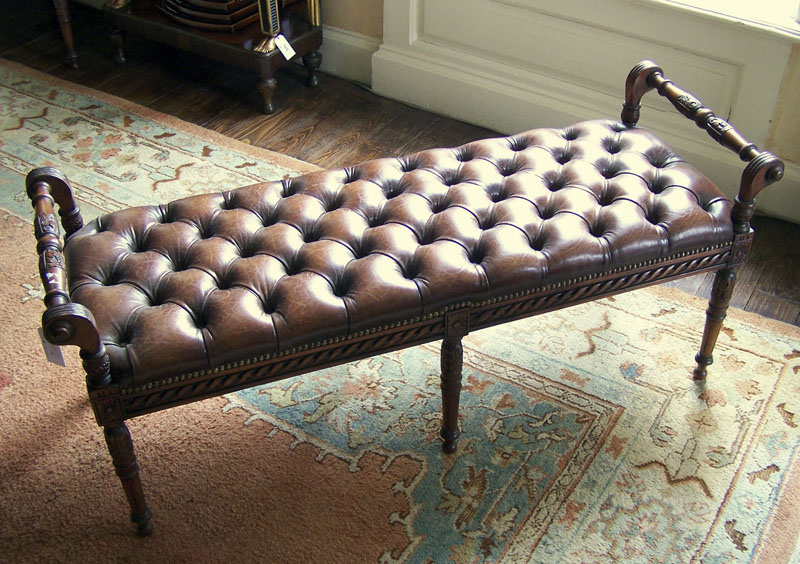 A pair of mahogany and leather upholstered window seats