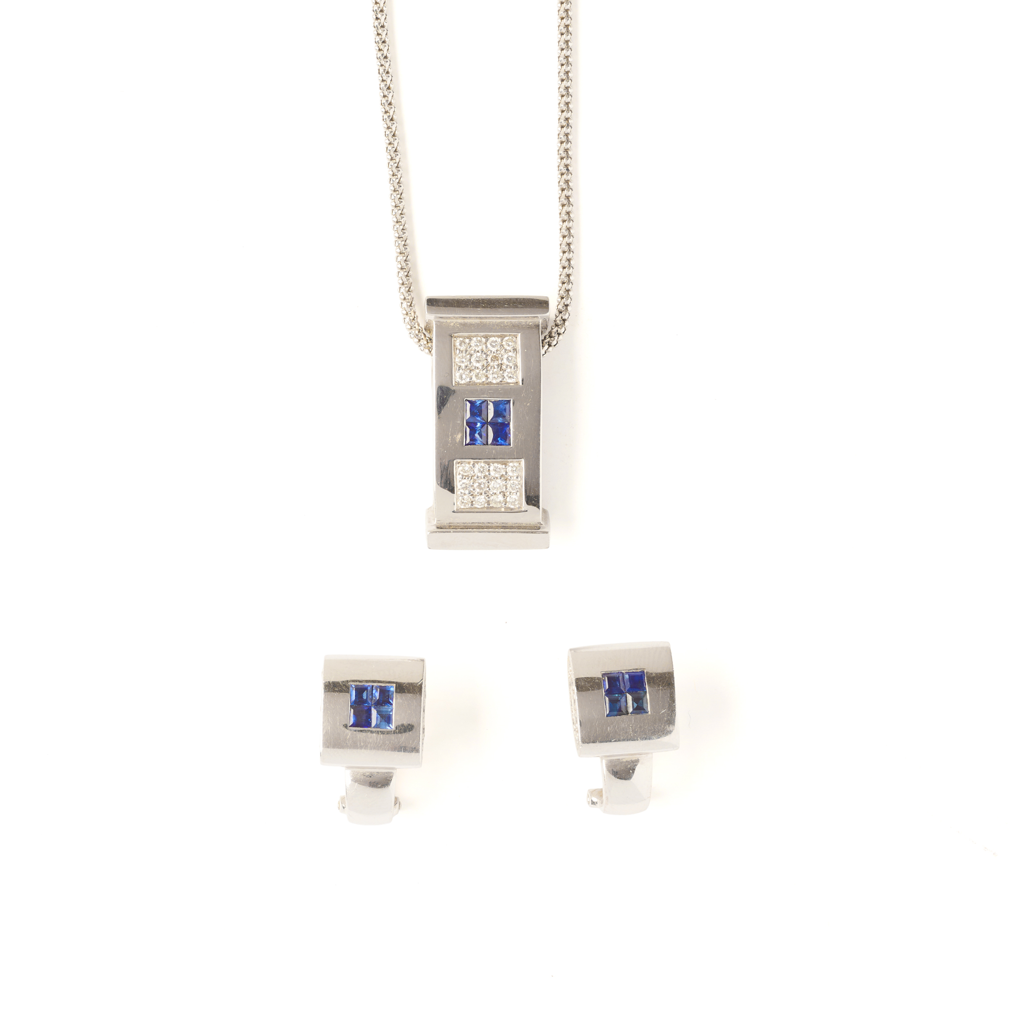 A sapphire and diamond pendant and matching earrings