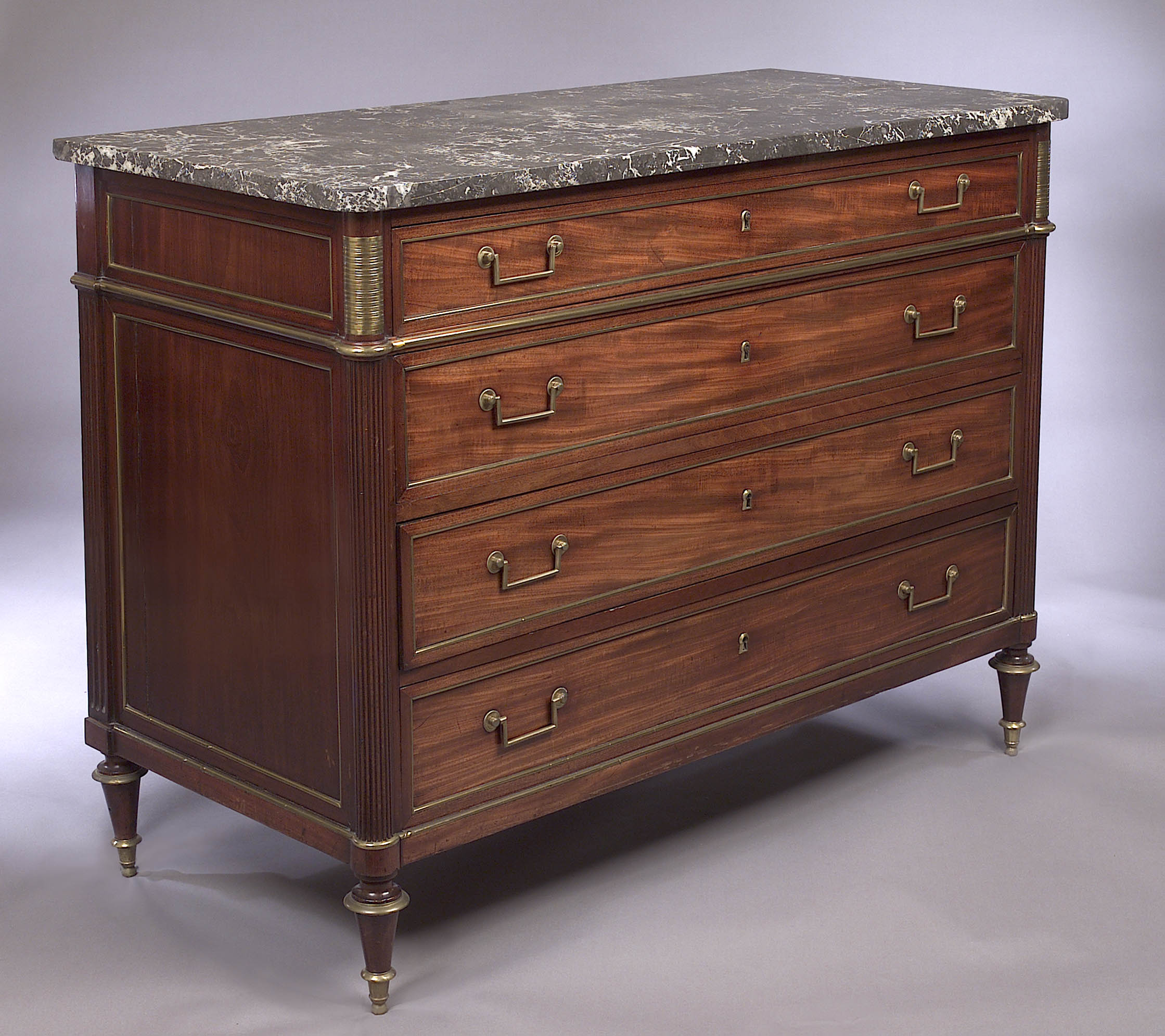 A Louis XVI marble topped mahogany and ormolu mounted commode