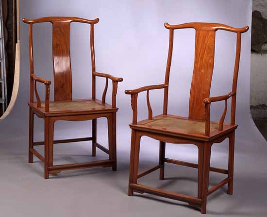A pair of Chinese teak open armchairs