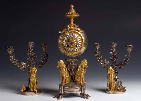 A 19th century polished steel and gilt metal clock garniture