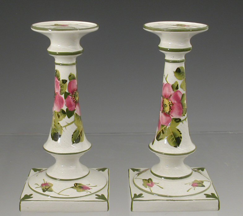 A pair of Wemyss candlesticks,