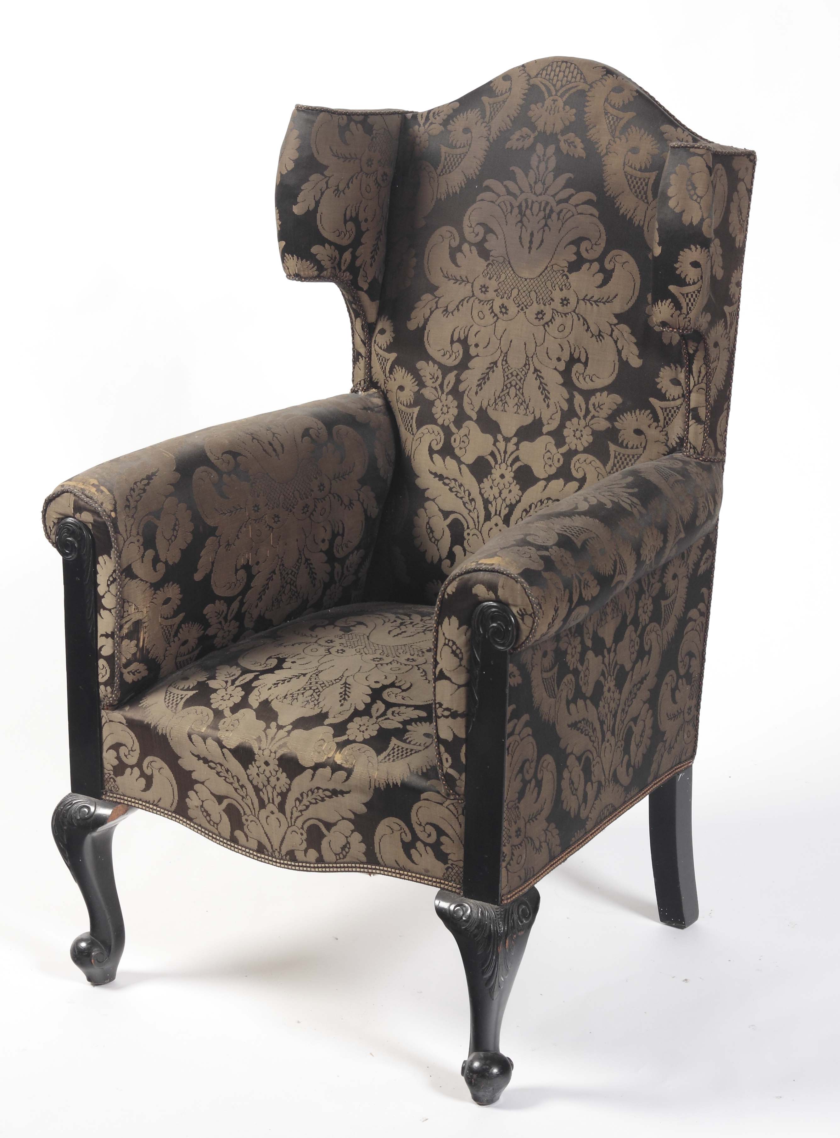 An Edwardian damask wing arm chair