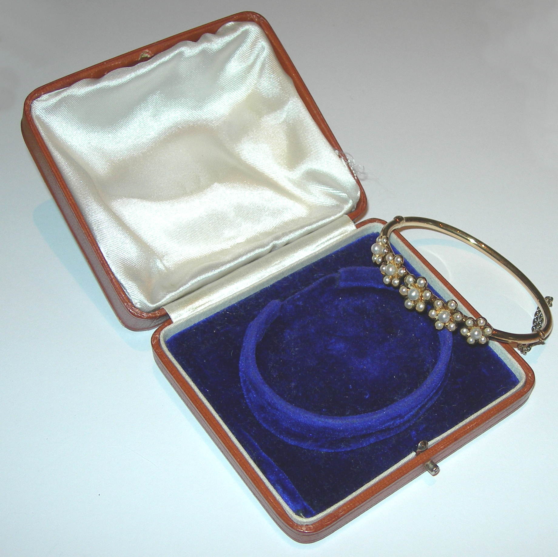 An Edwardian cultured pearl set bangle,