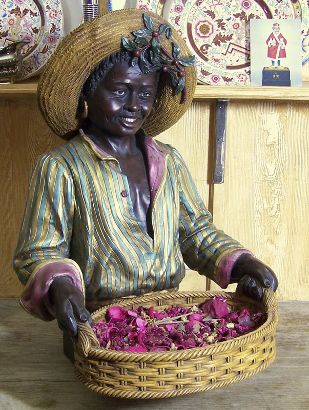 A late 19th/early 20th century carved and painted wood figure of a nubian boy