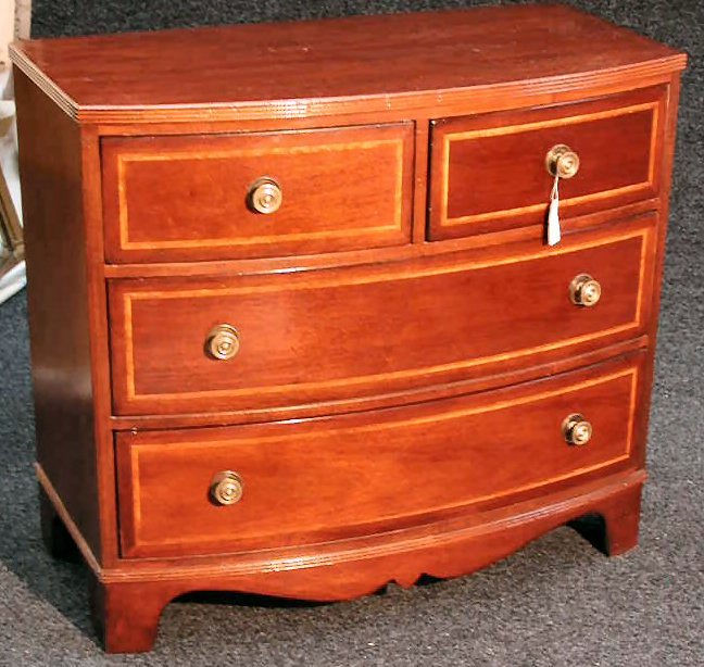 A pair of bow front chest of drawers,