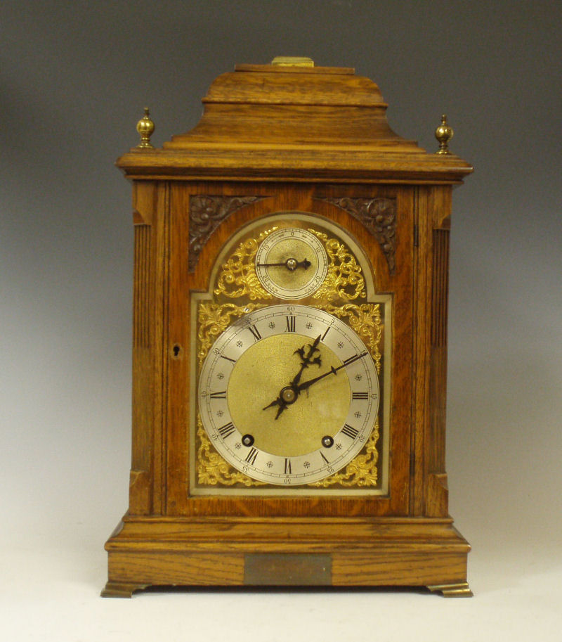 A Victorian oak cased chiming mantel clock