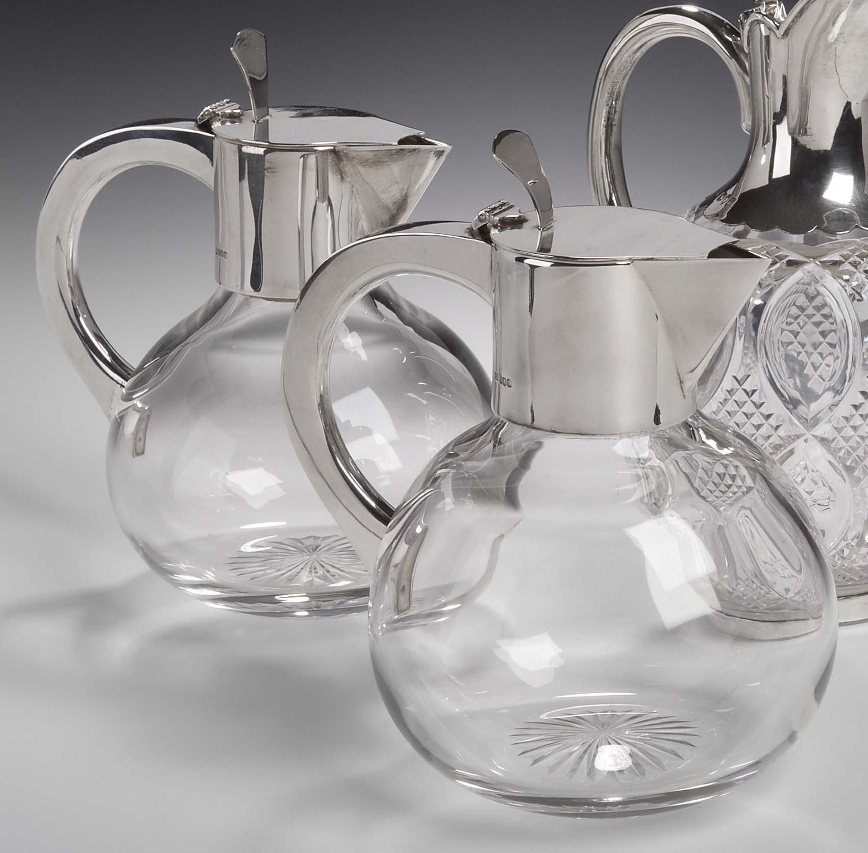 Hamilton & Inches - a pair of mounted glass claret jugs,