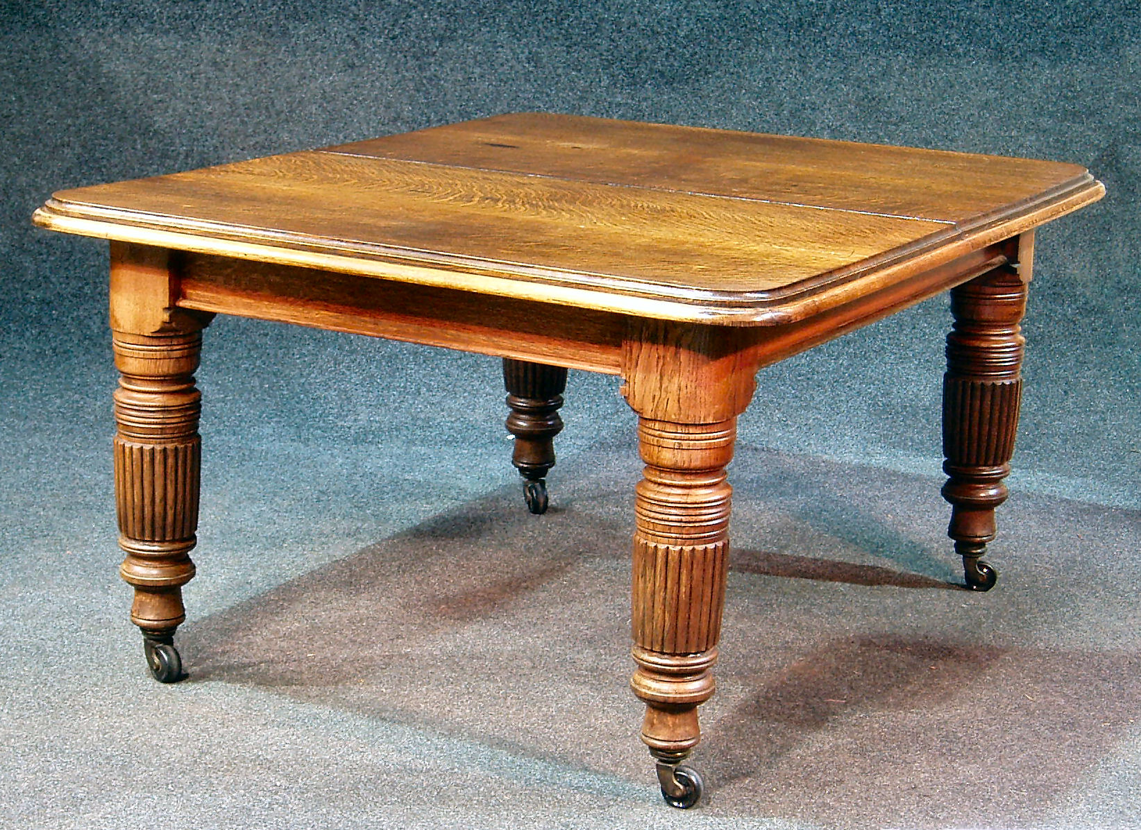 A Victorian oak extending dining table,