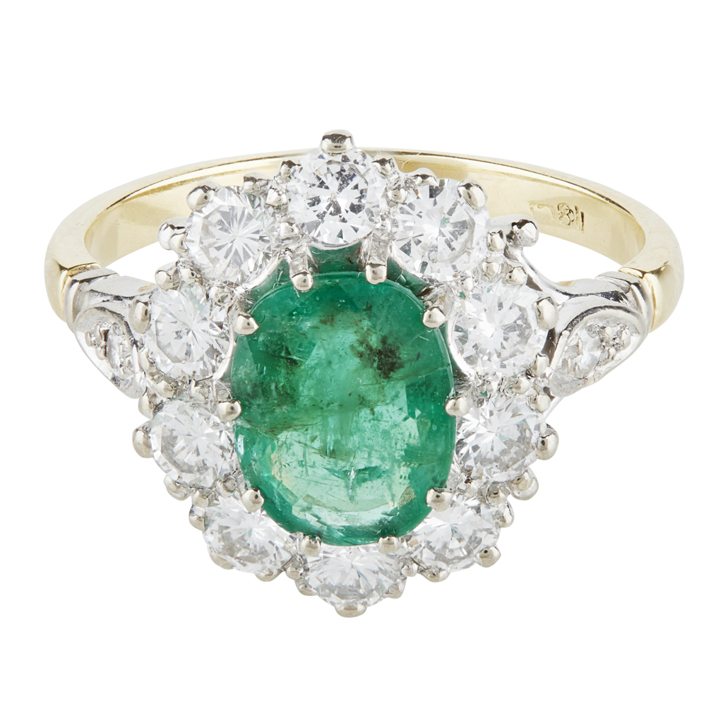 An emerald and diamond set cluster ring