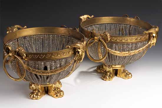 A pair of gilt bronze and glass standing lights of bowl form