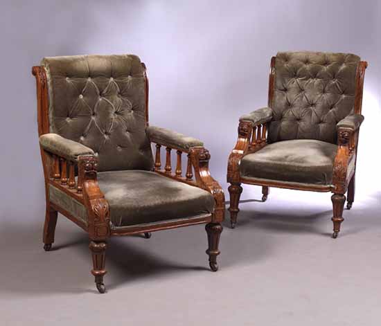A pair of late Victorian walnut library armchairs