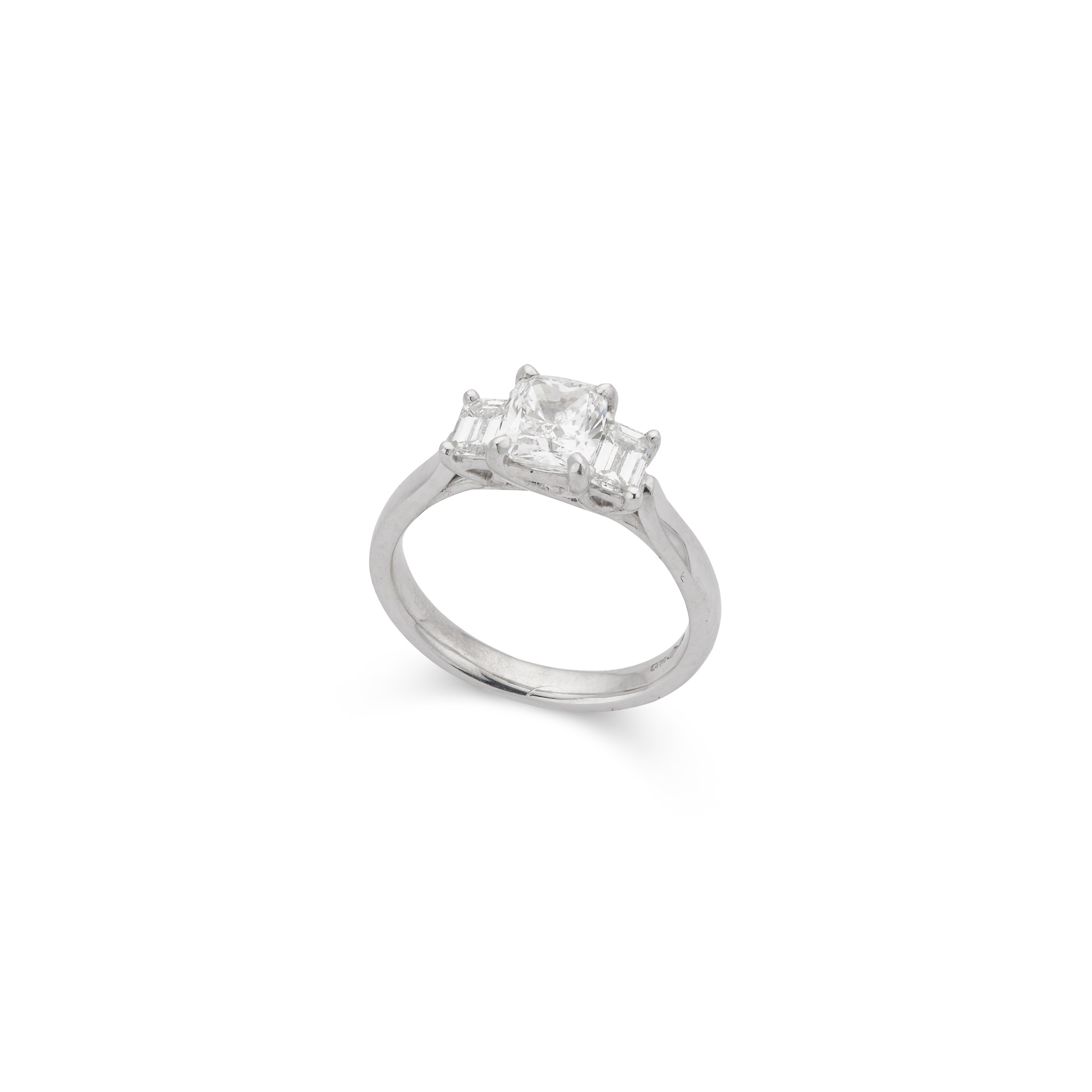 A cushion-cut platinum diamond three-stone ring