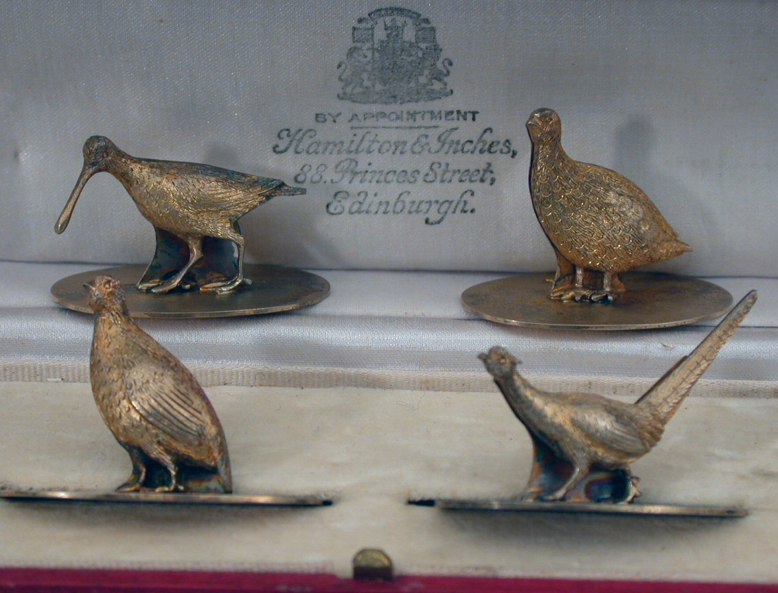 A cased set of four silver gilt menu holders