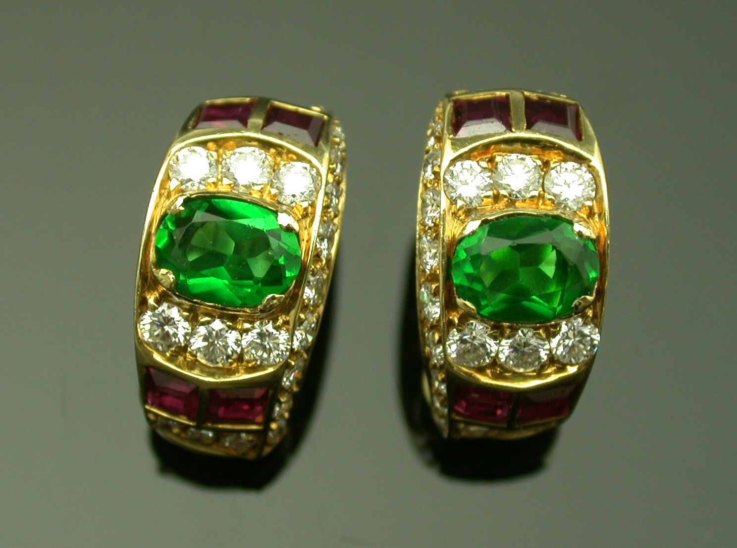 A pair of 18ct gold mounted multi gem set earrings,