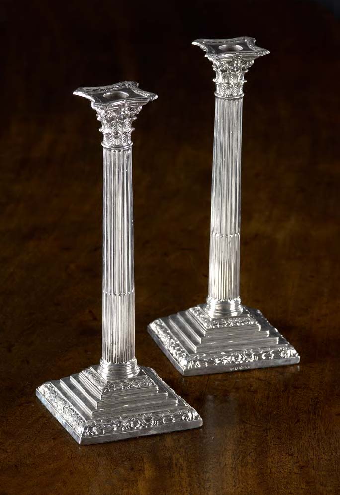A pair of Corinthian column candlesticks,