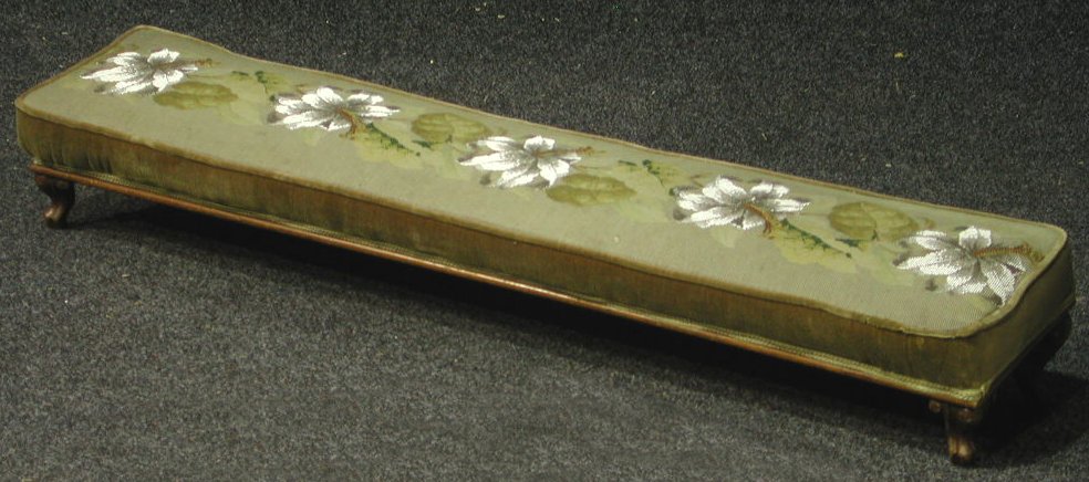 A mahogany framed upholstered footstool,