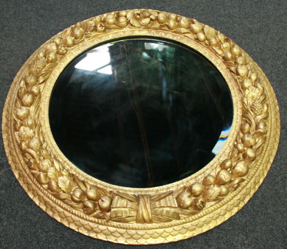 A large 19th century giltwood and gesso framed circular mirror