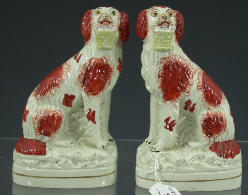 A pair of mid 19th century Staffordshire rust decorated seated spaniels