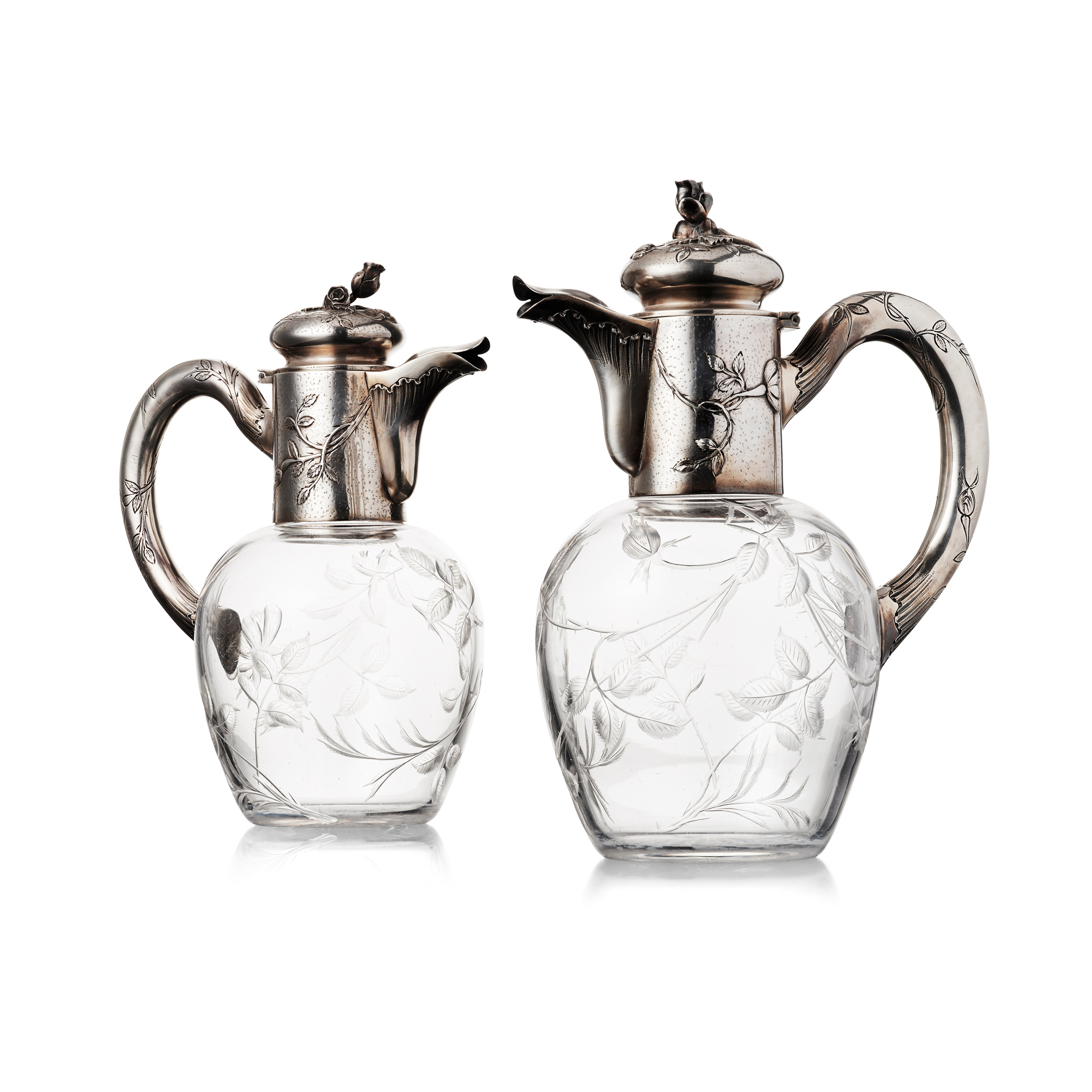 A PAIR OF FRENCH EARLY 20TH CENTURY SILVER MOUNTED CLARET JUGS